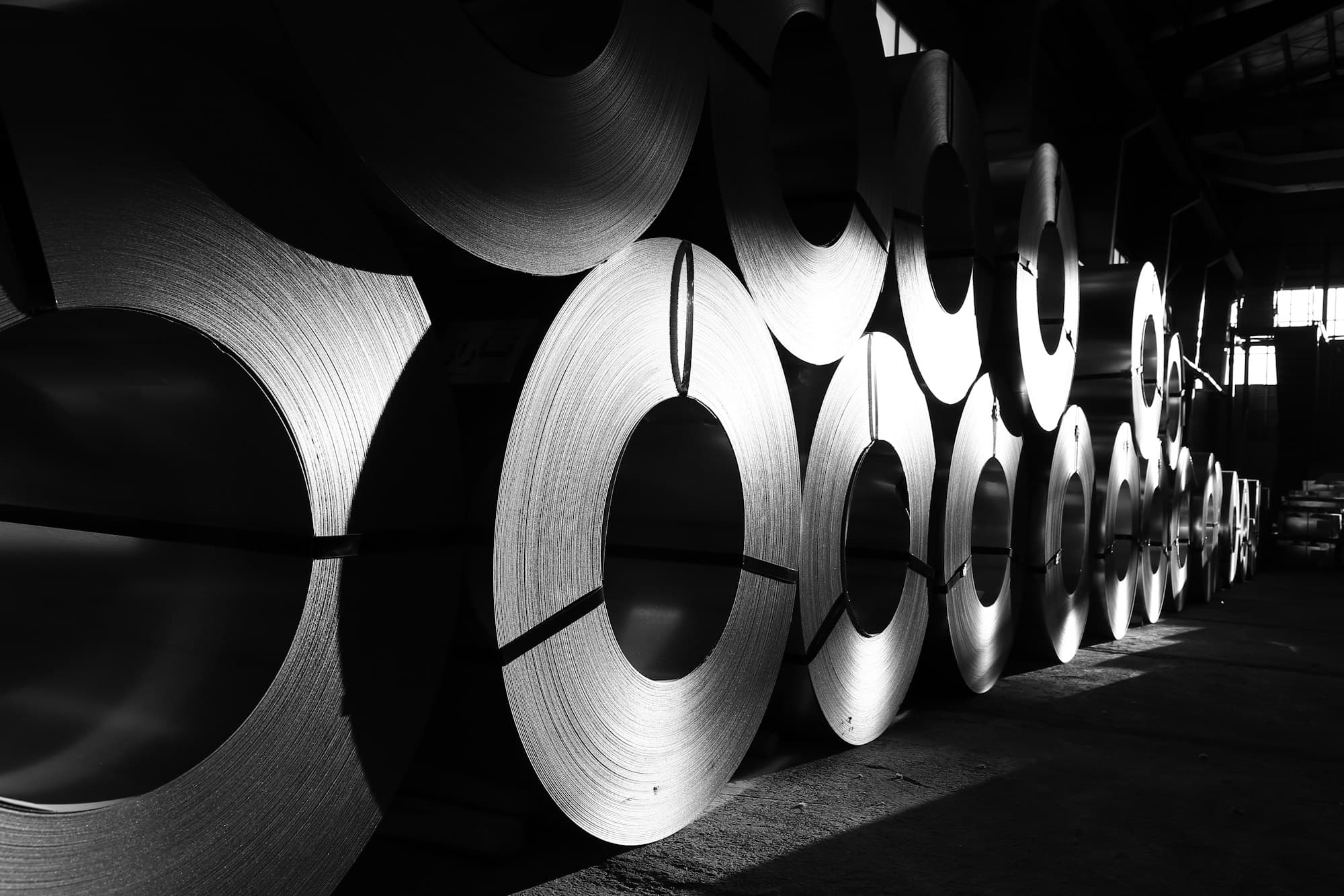 Rolls of steel coil in an industrial warehouse